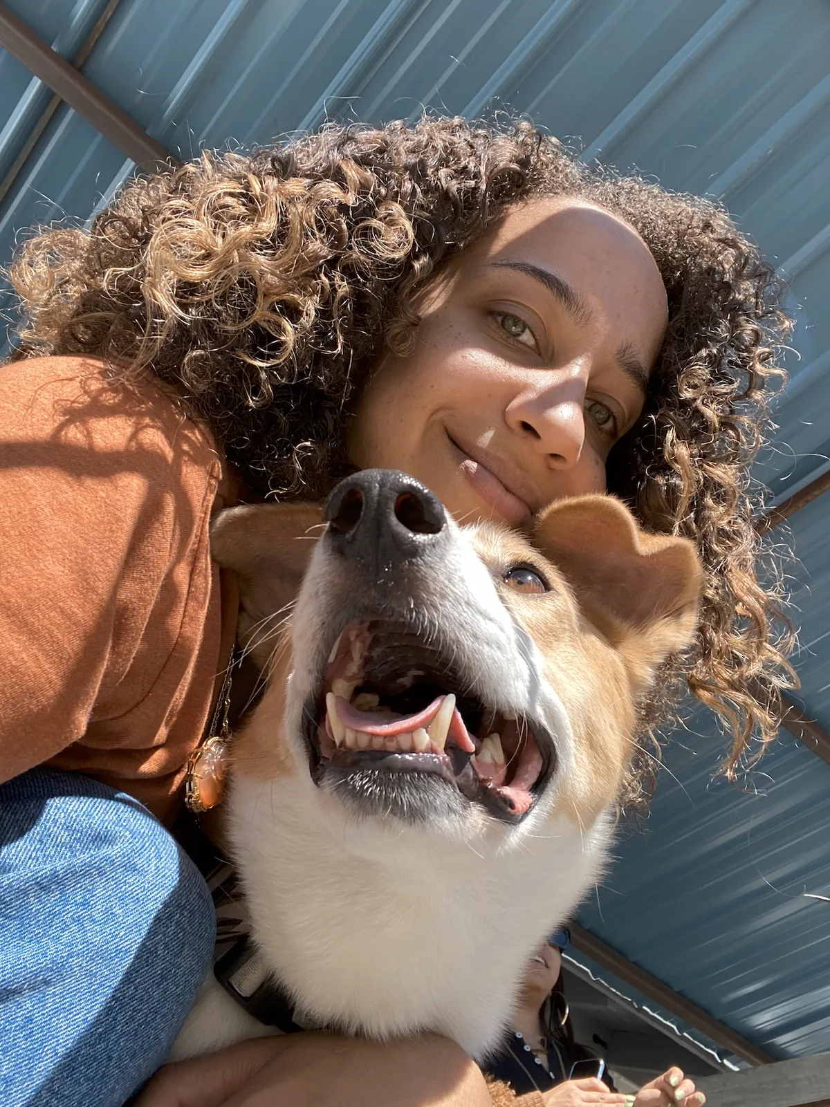 Simone smiling with Harlow outside